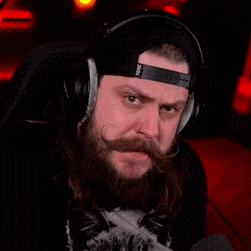 a man with a beard and mustache wearing headphones and a hat with the word doing on it