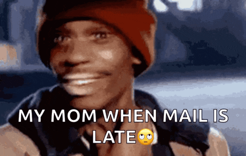 a man wearing a red hat is smiling and says my mom when mail is late