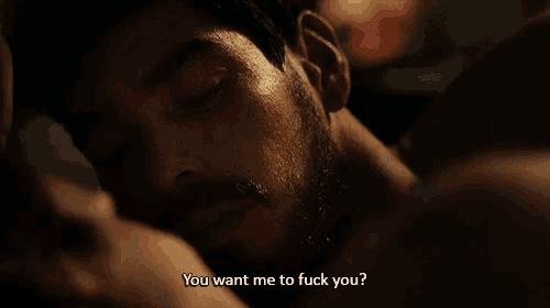 a man with a beard is laying down with his eyes closed and the words " you want me to fuck you " written below him
