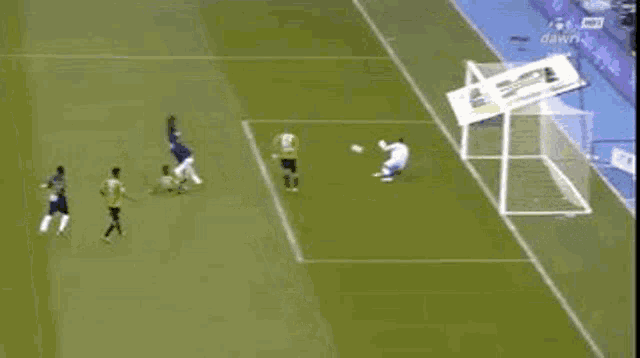 a group of soccer players are playing on a field .