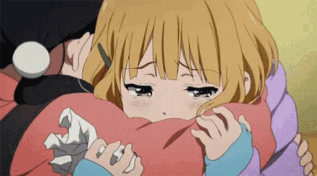 a girl with blonde hair is crying while holding a pink pillow