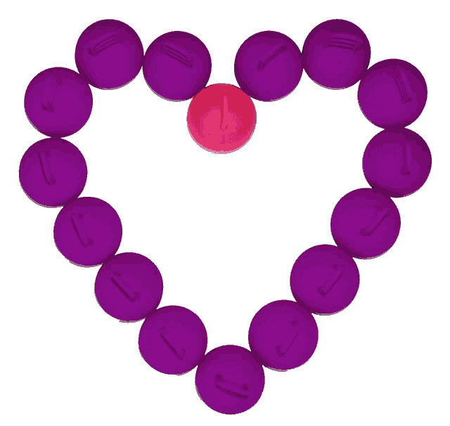 purple beads arranged in a heart shape with a pink bead in the middle