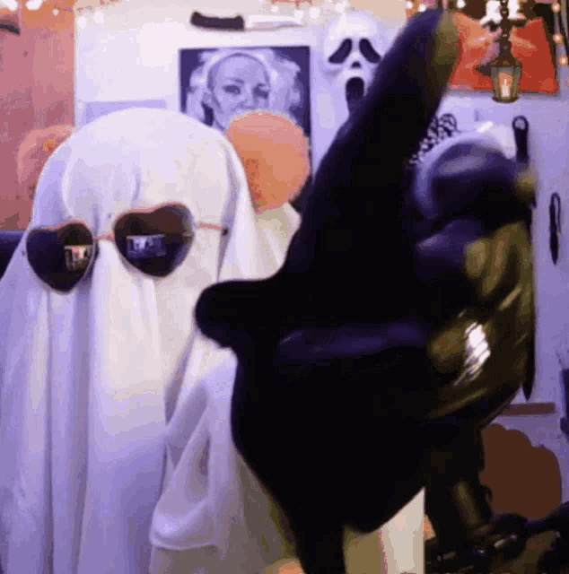 a man in a ghost costume with sunglasses on his head