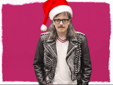 a man wearing a santa hat and studded jacket