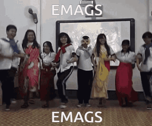 a group of people are dancing in front of a projector screen that says emags