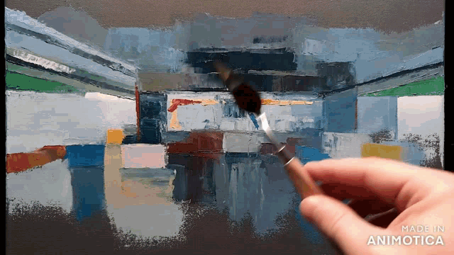 a hand is holding a brush in front of a painting that was made in animatica