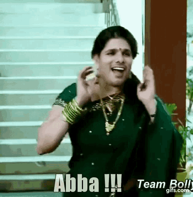 a woman in a green saree is singing the song abba !!!