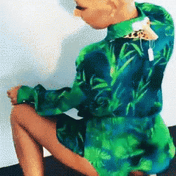 a person wearing a green and blue shirt with a giraffe on the collar