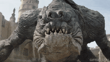 a close up of a monster with gifrun.com written on the bottom right