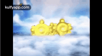 a couple of gold rings are floating in the sky .