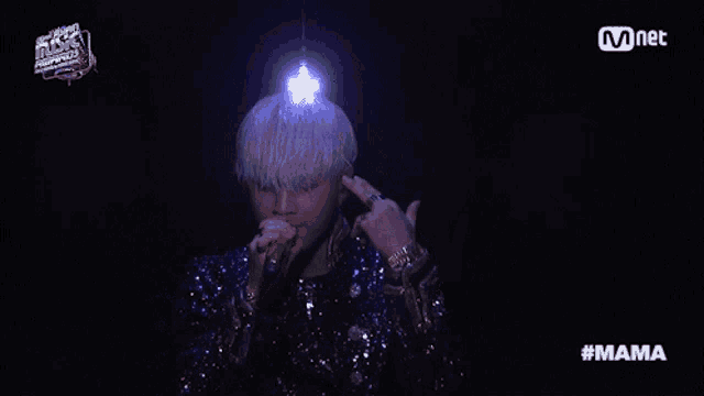 a man singing into a microphone with the hashtag #mama on the bottom right