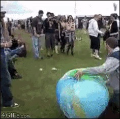 a group of people are gathered around a large inflatable globe ..