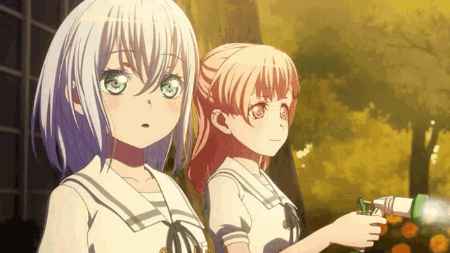 two anime girls are standing next to each other with one holding a lighter