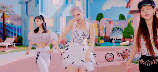 a group of girls are dancing in front of a pink house .
