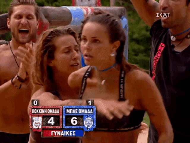 a woman in a bikini stands in front of a scoreboard which shows the score of 6 to 4