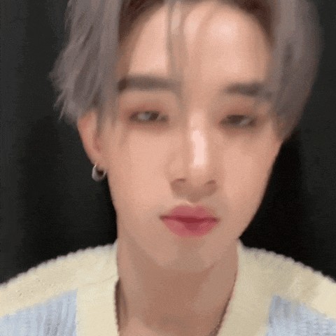 a close up of a person 's face with gray hair and red lips