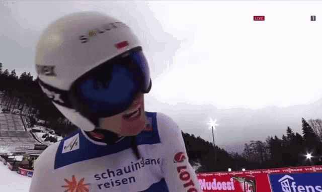 a person wearing a helmet and goggles with schauinland reisen written on the front