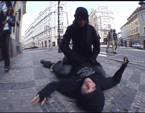 a man laying on the ground with a hoodie that says ' a ' on it