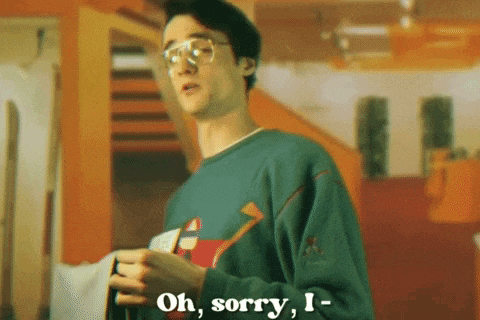 a young man wearing glasses and a green sweater says " oh sorry i "