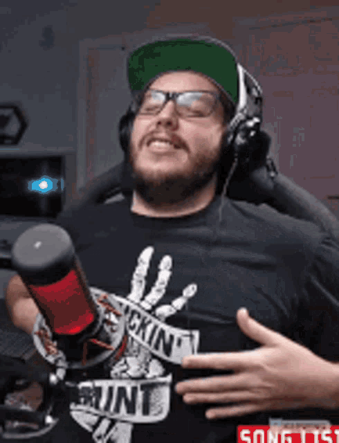 a man wearing headphones and a shirt that says " skin "