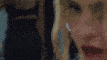 a close up of a woman 's face with her eyes closed