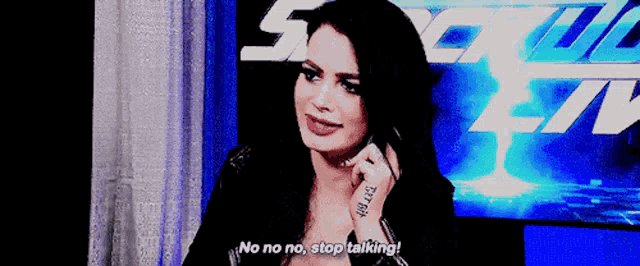 a woman talking on a cell phone with the words no no no stop talking behind her