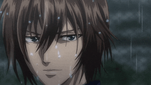 a close up of a person 's face with rain drops falling on it