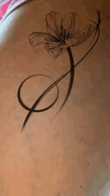 a woman has a tattoo of a flower and a circle