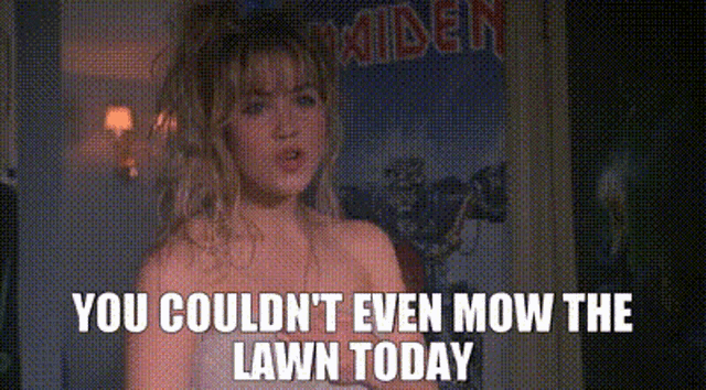 a woman is standing in front of a poster that says ' you couldn t even mow the lawn today '