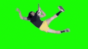 a woman is falling on a green screen while holding a tennis racket .