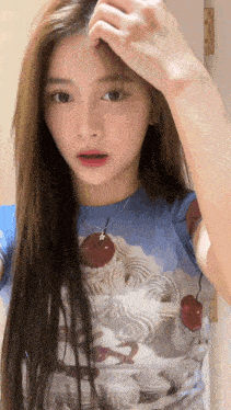 a woman in a blue shirt with a cherry on it