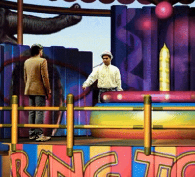 a man stands on a stage in front of a sign that says ' rang to '