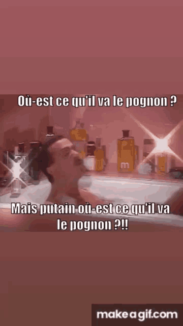 a man is taking a bath in a bathtub with a make a gif.com button