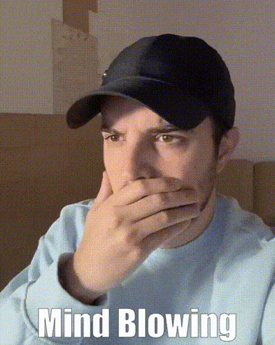 a man wearing a hat is covering his mouth with his hand and the words mind blowing are written below him