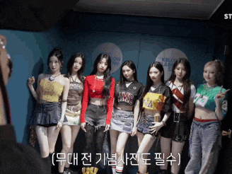 a group of girls standing next to each other with one wearing a shirt that says ' lmc ' on it