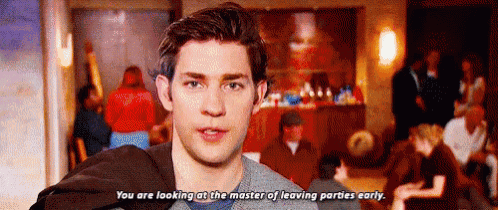 a man is standing in front of a crowd of people and saying `` you are looking at the master of leaving parties early ''