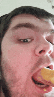 a close up of a man 's face with his mouth open