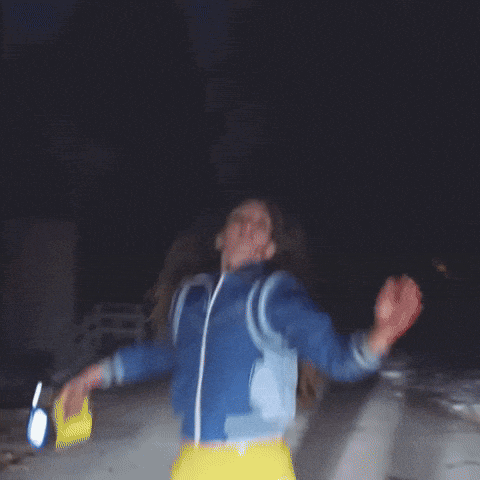 a woman in a blue jacket with blood on her face