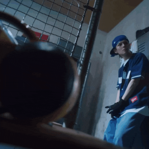 a man wearing a blue shirt that says supreme