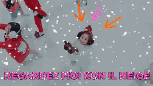 a girl is laying in the snow with the words regardez moi kon il neige
