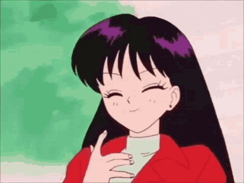 a girl in a red jacket is smiling and giving a thumbs up .