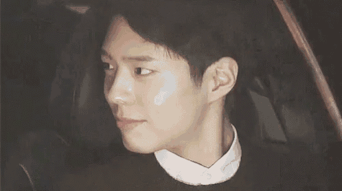a young man is smiling while sitting in a car .