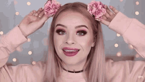 a woman with pink hair and braces is wearing pink flowers in her hair