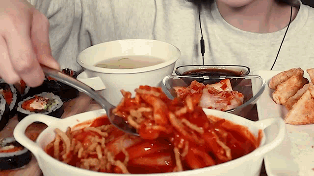 a person is eating a bowl of food and a bowl of soup