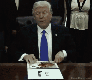 a man in a suit and tie is sitting at a desk with a sign that says it 's a trump
