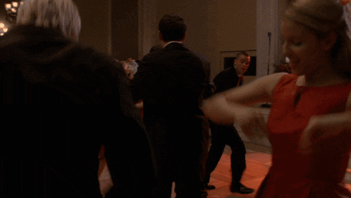 a man in a wheelchair is dancing with a group of people on a dance floor