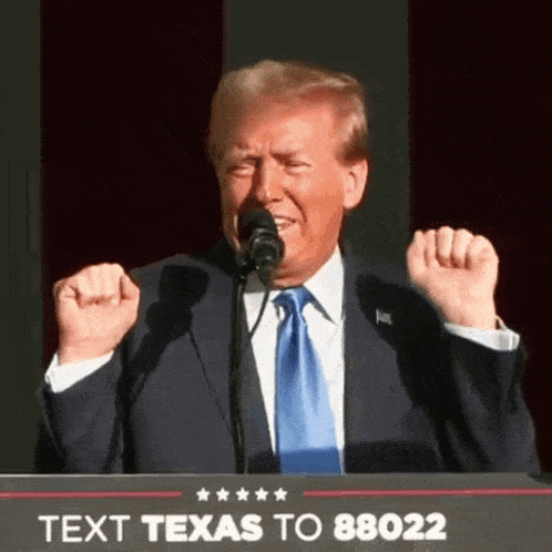 a man in a suit and tie stands at a podium with a sign that says text texas to 88022