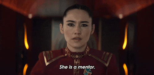 a woman in a red uniform is saying she is a mentor