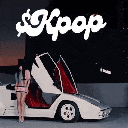 a woman stands in front of a white sports car with the word kpop written on it