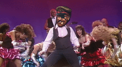 a group of women are dancing in front of a man with a pirate hat and eye patch